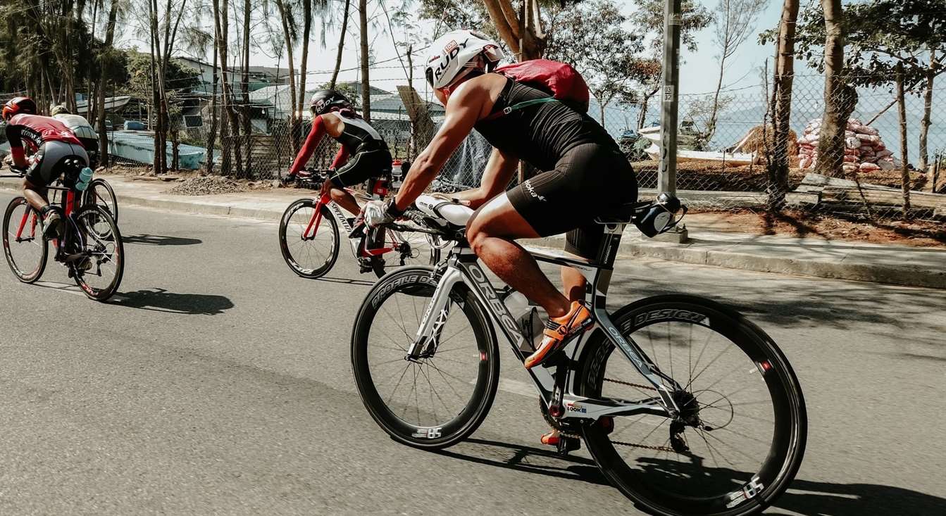 bikers biking on a road